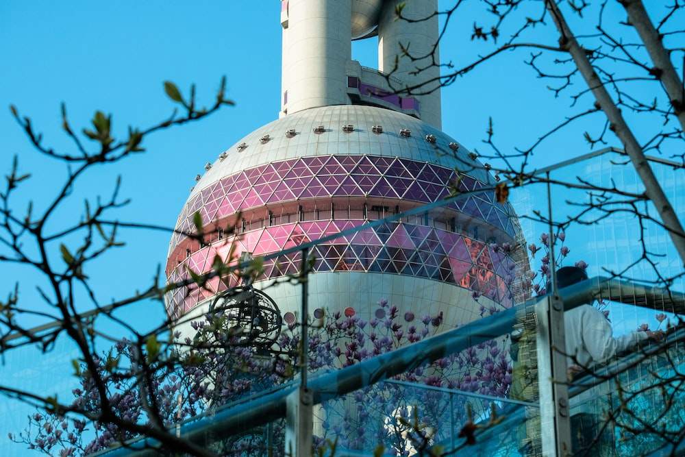 a tall building with a pink and white dome