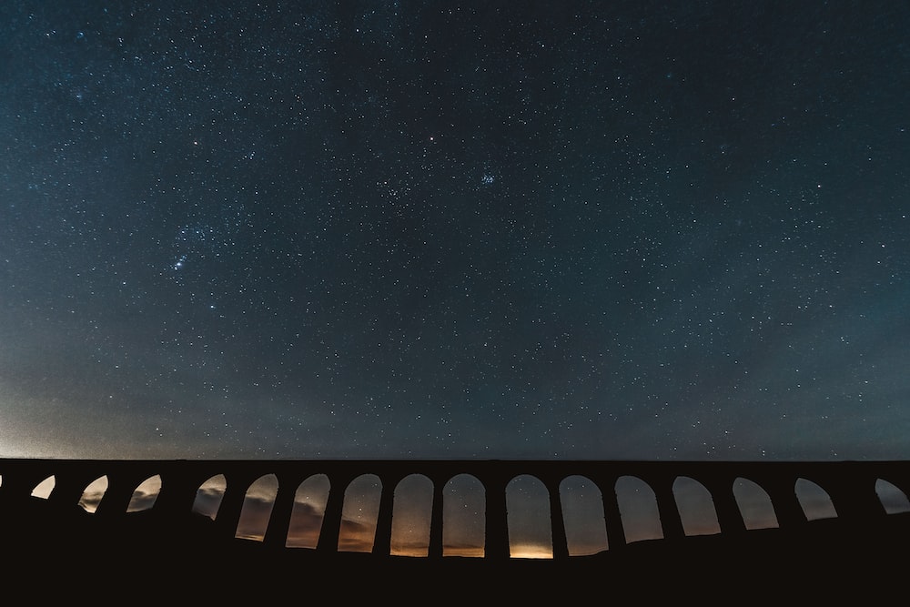 a view of the night sky over a bridge