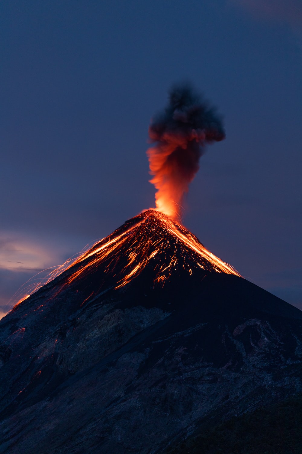 a volcano erupting at night
