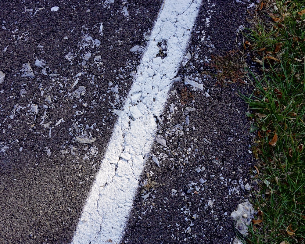 a white line painted on the side of a road