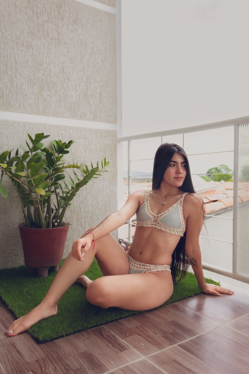 a woman in a bikini sitting on the floor