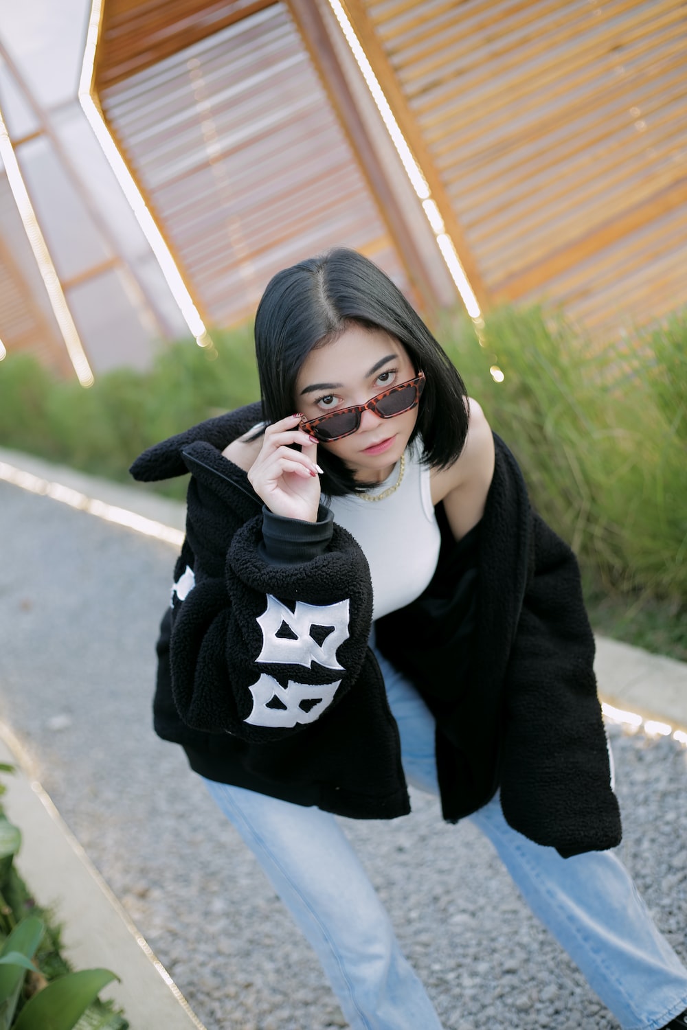 a woman in a black sweater talking on a cell phone