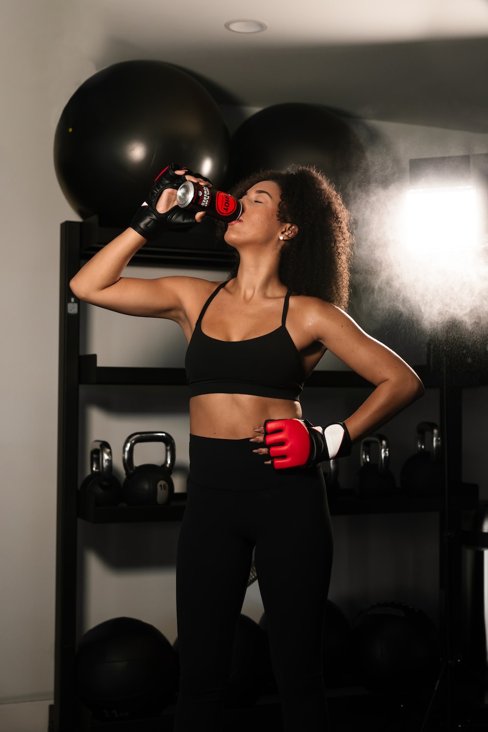a woman in a sports bra top drinking from a bottle
