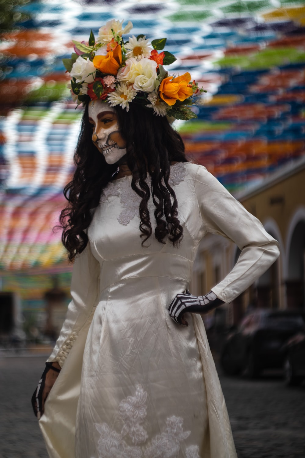 a woman wearing a mask and holding flowers
