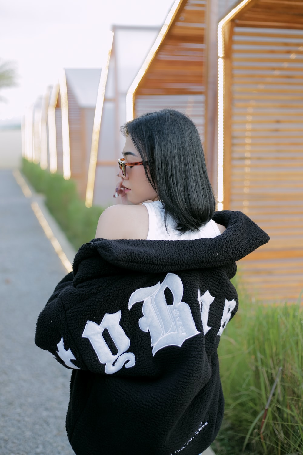 a woman with black hair wearing a black and white sweater