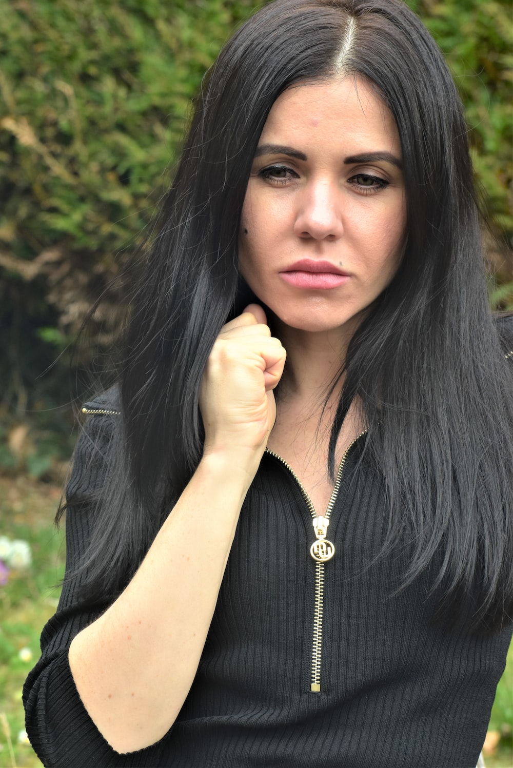 a woman with long black hair posing for a picture