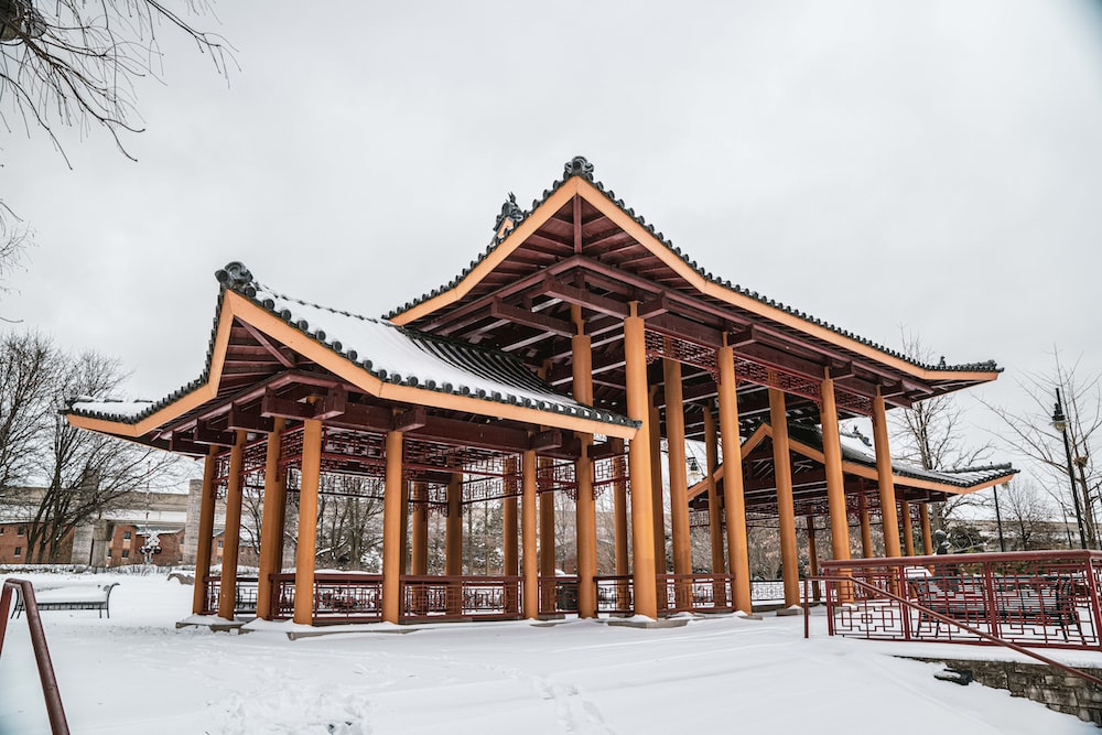 a wooden structure in the middle of a snowy field