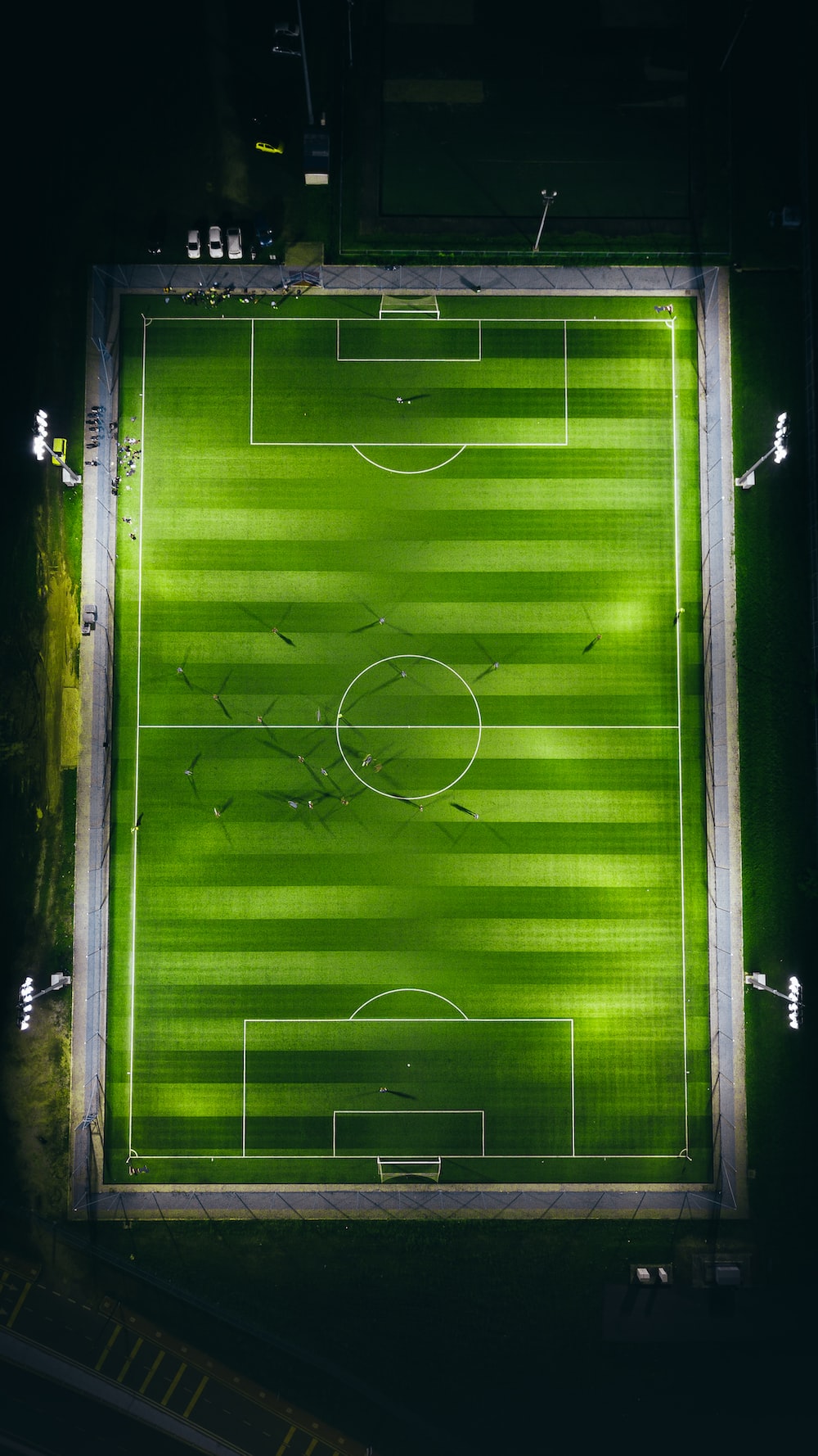 bird's-eye view photography of green soccer field with lights
