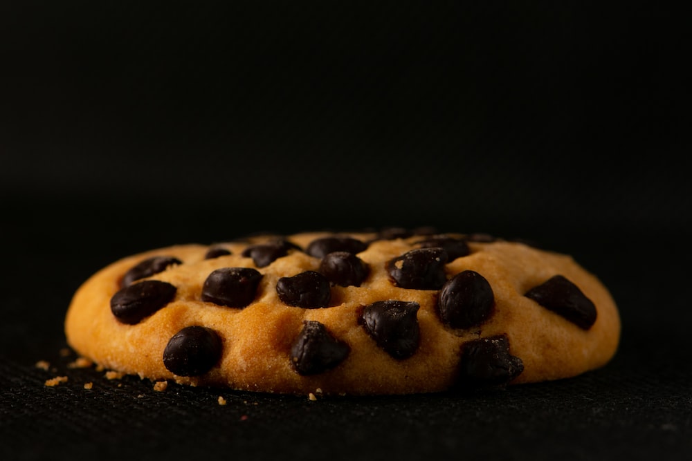 brown and black cookies on black surface