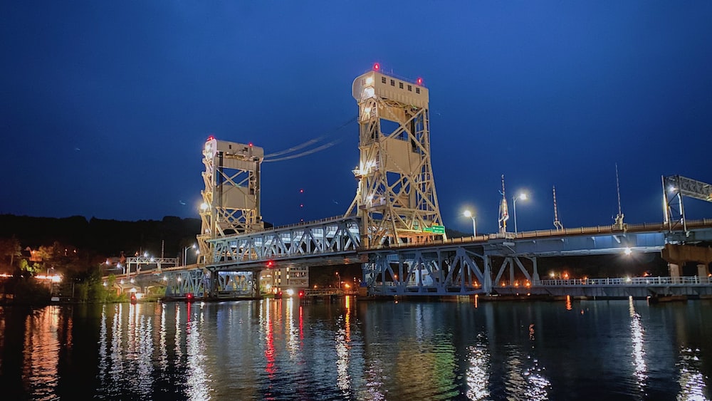 brown bridge over water during night time