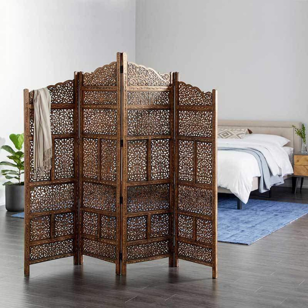 brown wooden cabinet near white bed