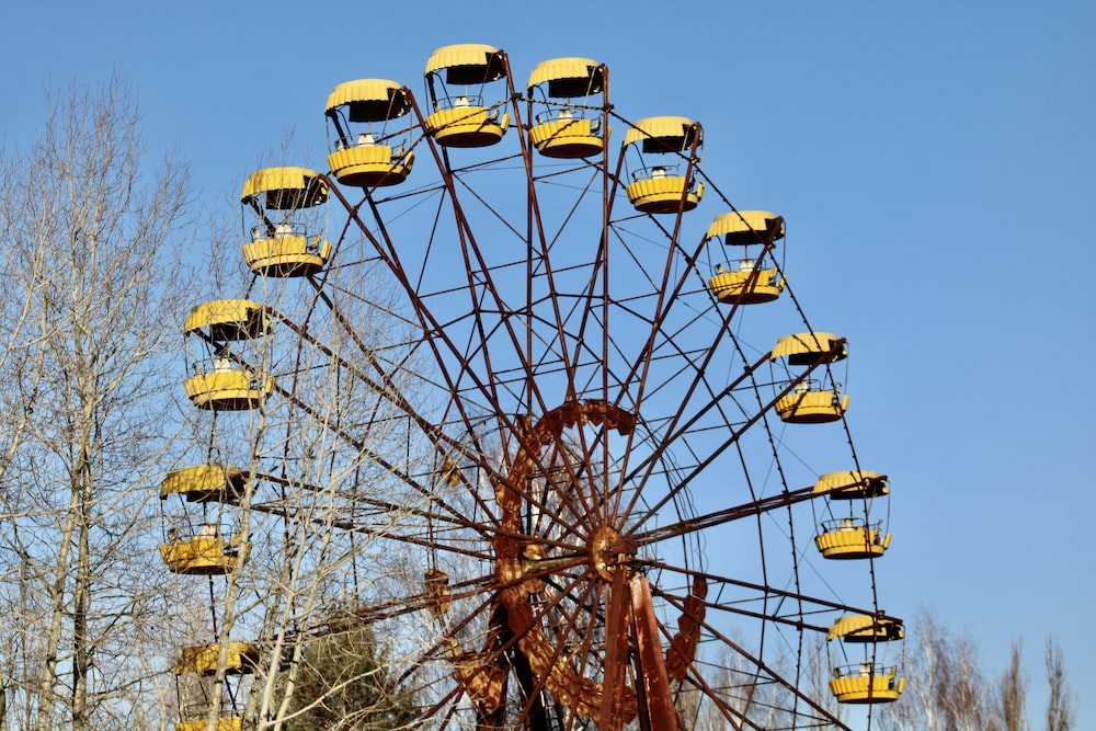 closeup photo of ferris wheel near bare trees