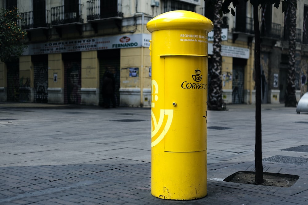 cylindrical yellow steel mail box