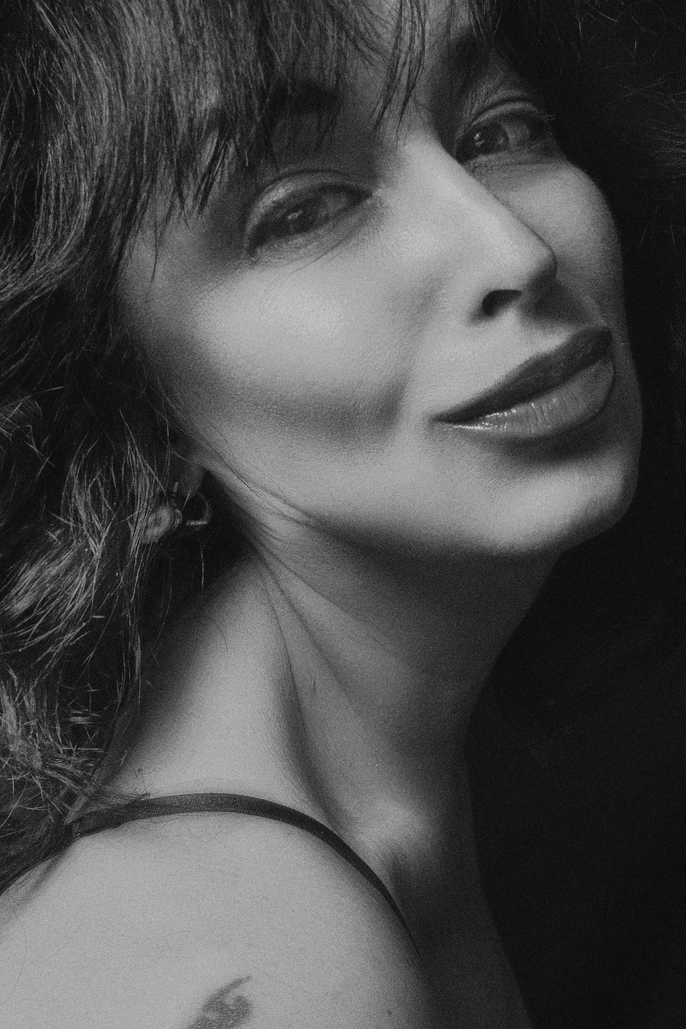 grayscale photography of woman smiling