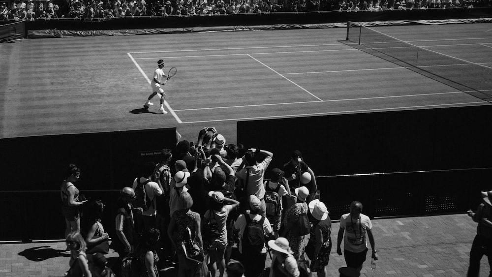 grayscale photo of person playing tennis