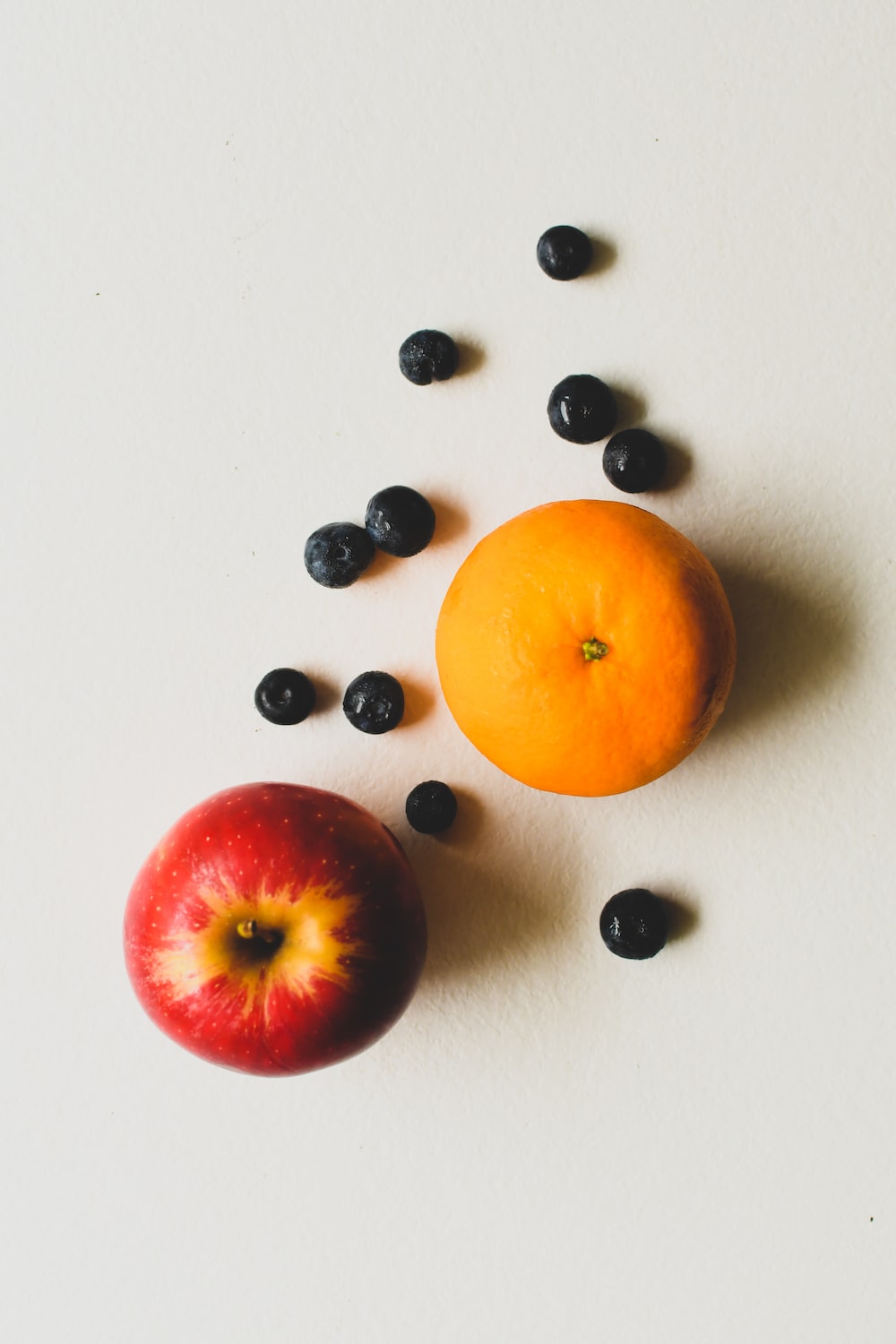 orange fruit beside black and white beads