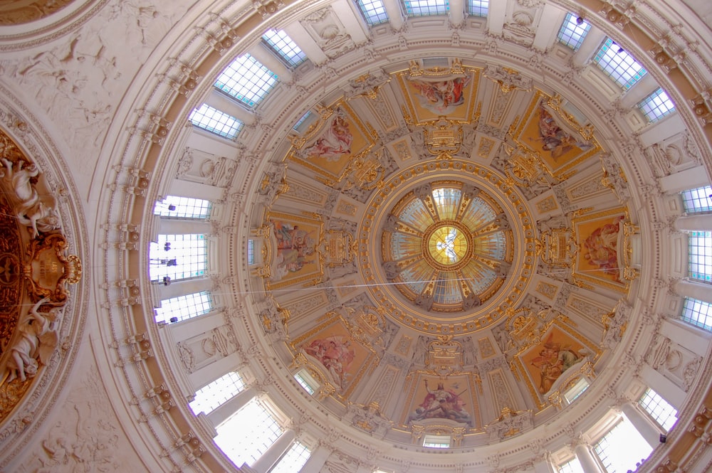 the ceiling of a large building with many windows