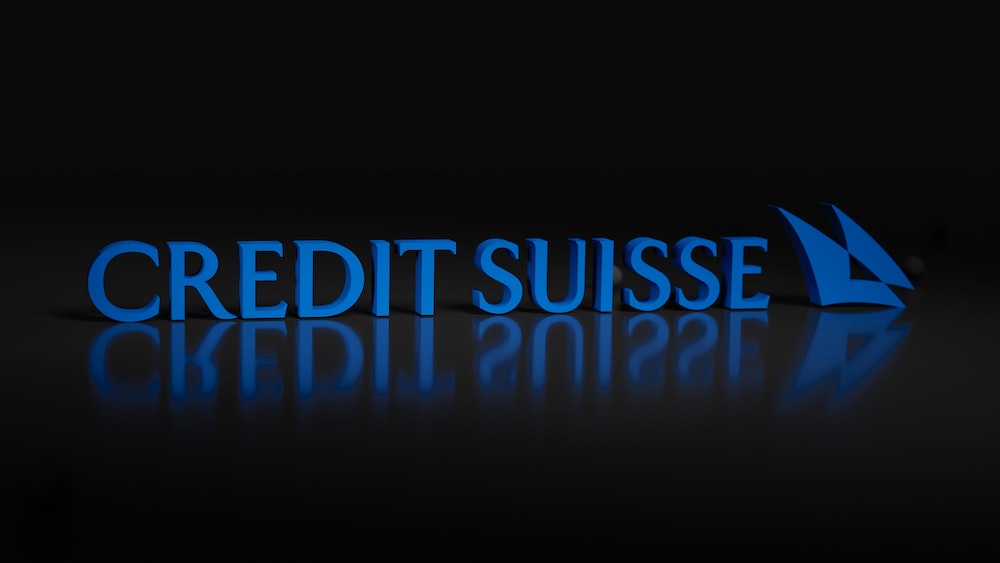 the words credit suise are lit up in the dark