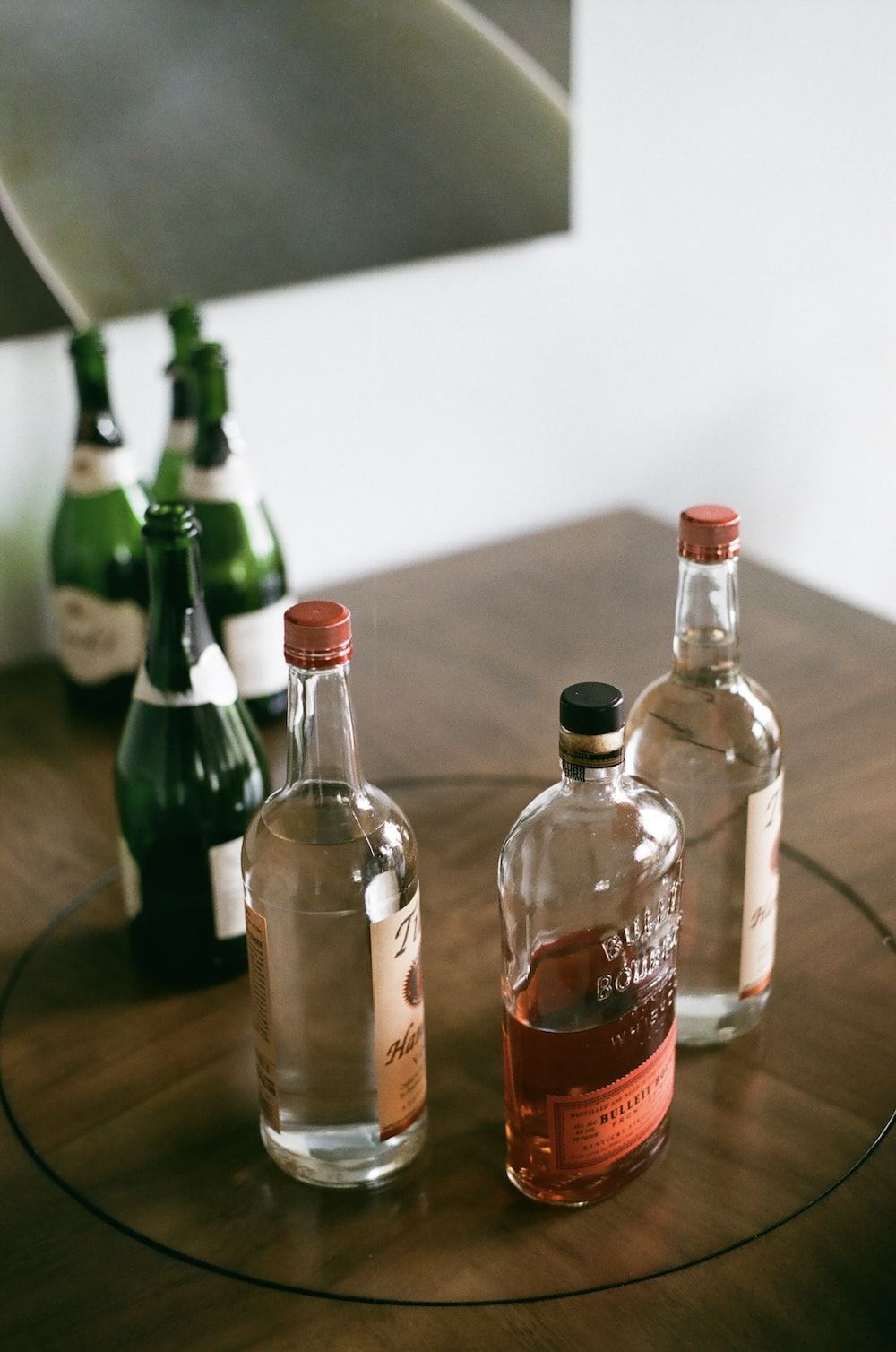 three bottles of alcohol sitting on a table