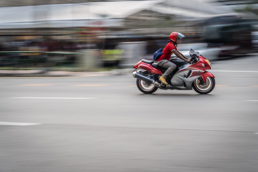 time lapse photography of person riding motorcycle on road