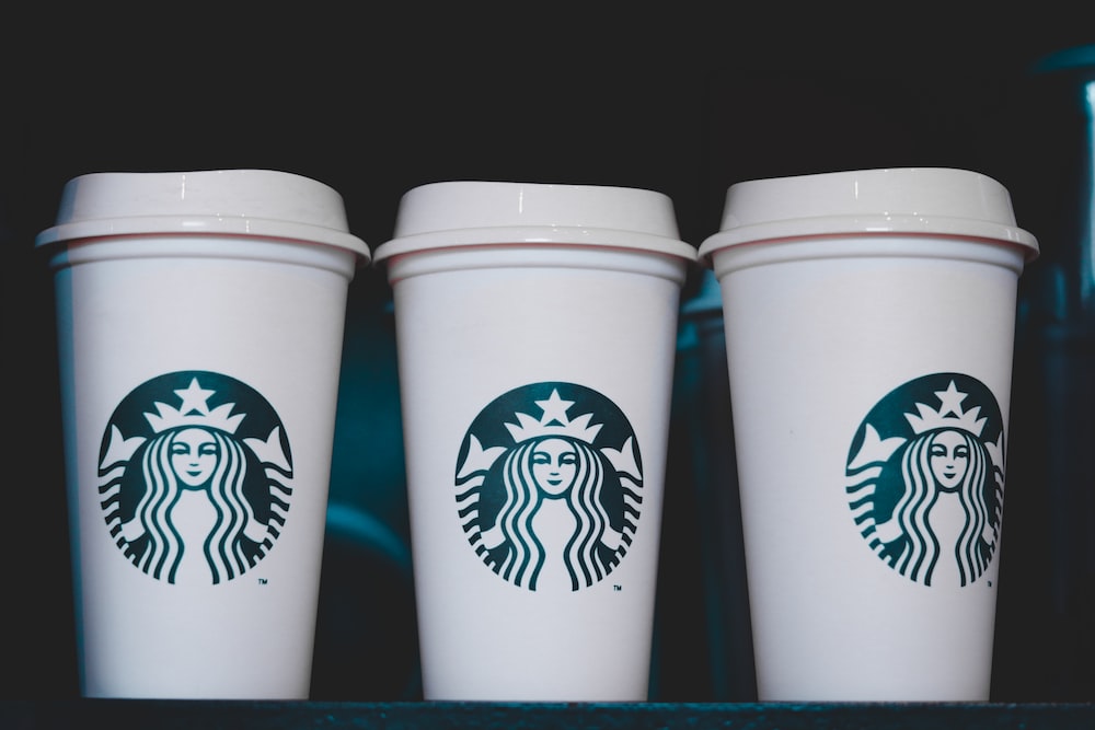 two white starbucks disposable cups