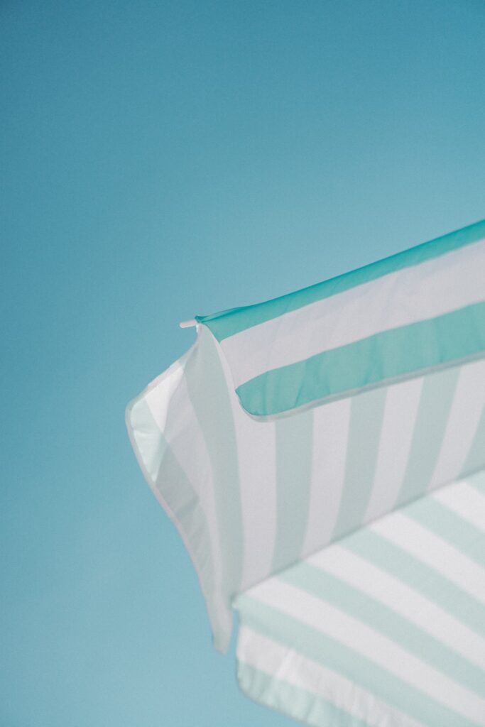 white and green striped parasol during daytime photo