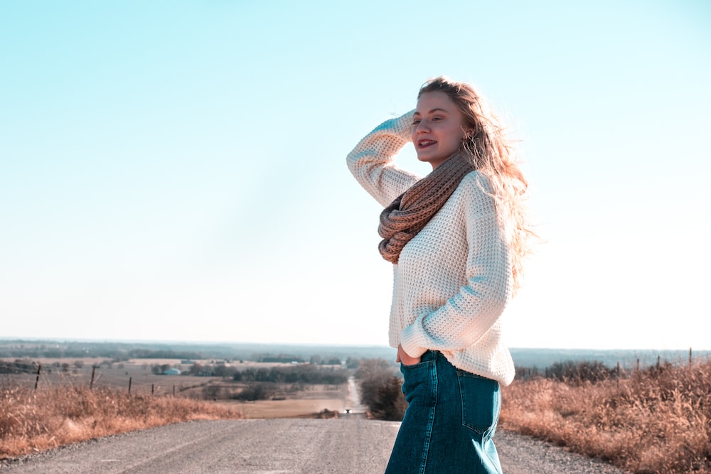 woman in white sweater on rough road