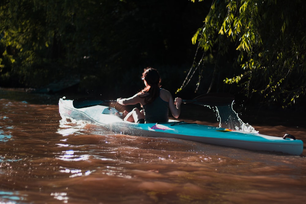 woman paddling through river