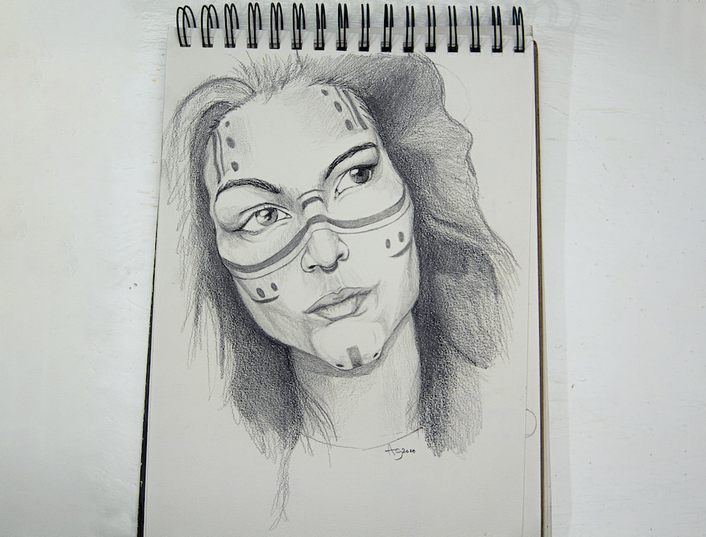 womans face sketch on white paper